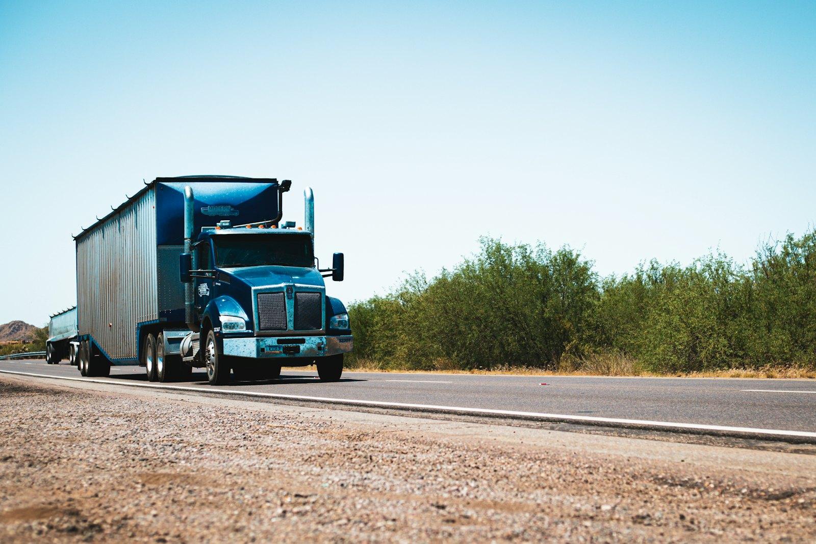Blue semi truck driving on a highway